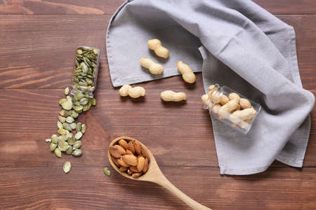 Different healthy nuts and seeds on wooden backgroundの写真素材