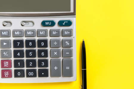 Modern calculator and pen on color backgroundの写真素材