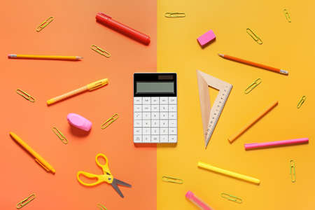 Modern calculator and stationery on color backgroundの写真素材