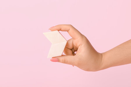 Female hand with makeup sponges on color backgroundの写真素材