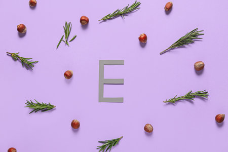Letter E with healthy nuts and herbs on color backgroundの写真素材