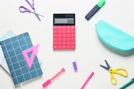 Modern calculator and stationery on white backgroundの写真素材