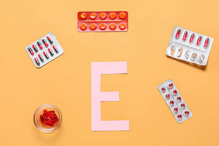 Letter E with different pills on color backgroundの写真素材
