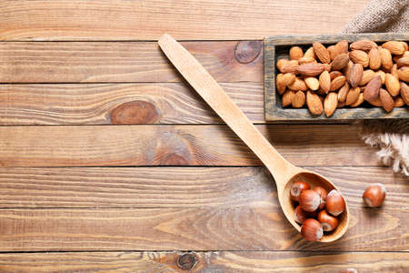 Healthy hazelnut and almond nuts on wooden backgroundの写真素材
