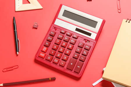 Modern calculator and stationery on color backgroundの写真素材