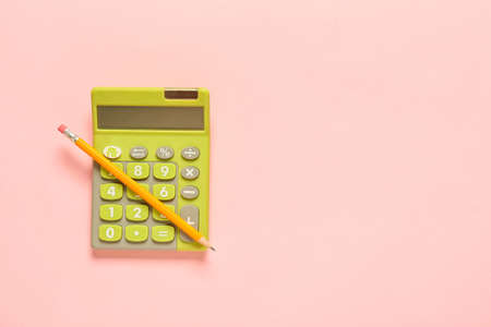 Modern calculator and pencil on color backgroundの写真素材