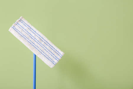 Floor mop on color background, closeup