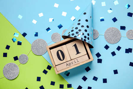 Party decor and calendar with date of April Fools Day on color backgroundの写真素材