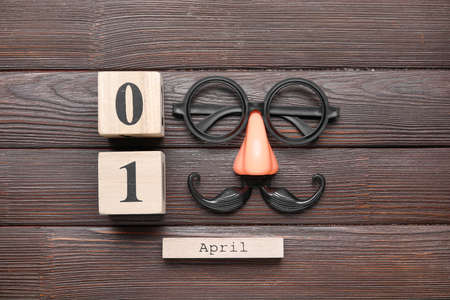Party decor and calendar with date of April Fools Day on wooden backgroundの写真素材