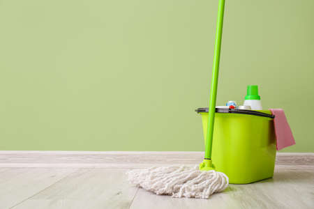 Set of cleaning supplies near color wallの写真素材