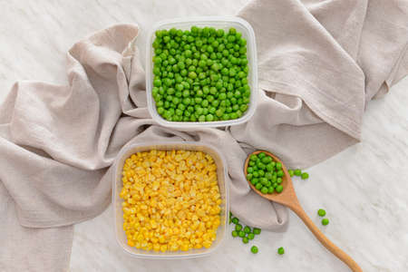 Plastic containers with vegetables on light backgroundの写真素材