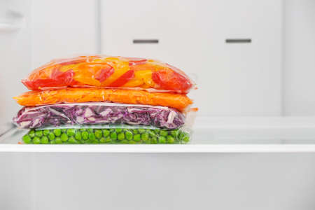 Plastic bags with vegetables in refrigerator, closeupの写真素材