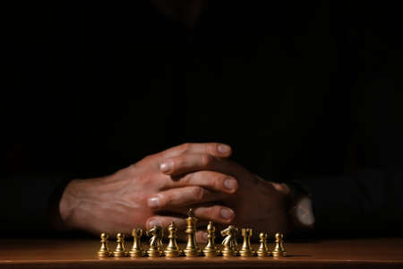Man playing chess on dark background, closeupの写真素材