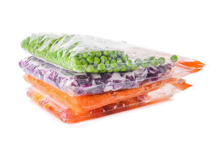 Plastic bags with vegetables on white backgroundの写真素材