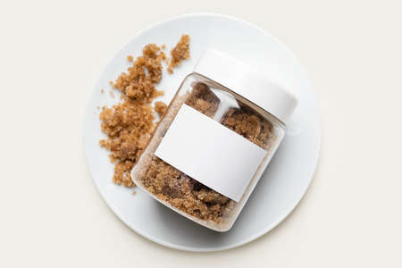 Jar of body scrub on light background