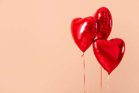 Heart shaped air balloons on color backgroundの写真素材