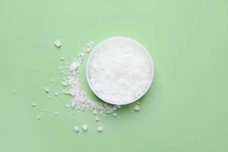 Jar of body scrub on color background