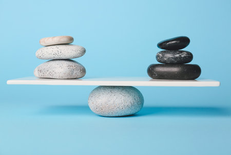 Spa stones on teeterboard against color background. Concept of balanceの写真素材