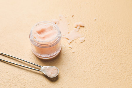 Jar of body scrub on color backgroundの写真素材
