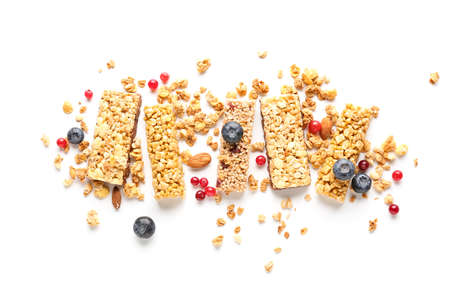 Healthy cereal bars and berries on white background
