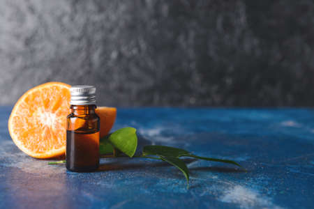 Bottle of essential oil on dark backgroundの写真素材