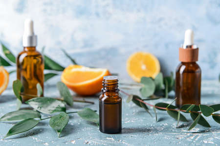 Bottle of essential oil on color backgroundの写真素材