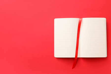 Blank book with bookmark on color backgroundの写真素材