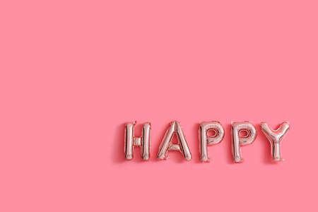 Word HAPPY made of air balloons on color wallの写真素材