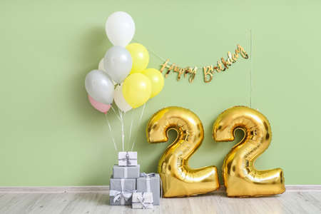 Air balloons with gifts near green wallの写真素材