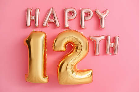 Text HAPPY 12TH made of air balloons on pink backgroundの写真素材