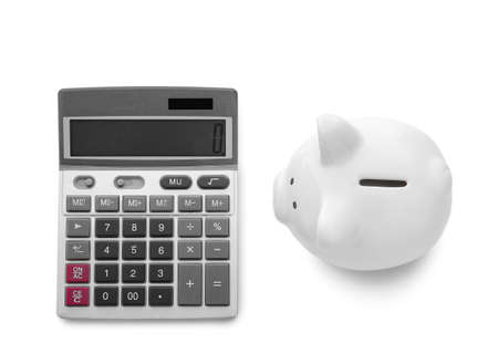 Calculator with piggy bank on white backgroundの写真素材