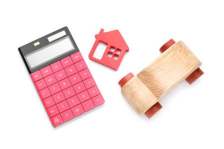 Calculator with house and car figures on white backgroundの写真素材