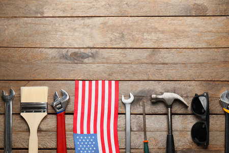 Set of tools and USA flag on wooden background. Labor Day celebrationの写真素材
