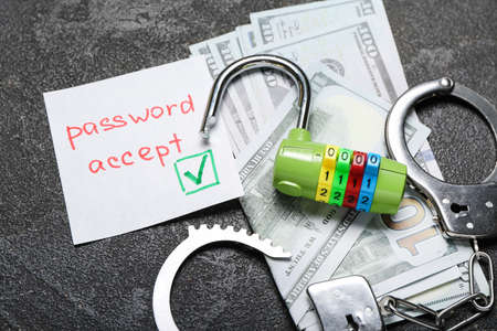 Money, handcuffs and lock on dark background. Hacking conceptの写真素材