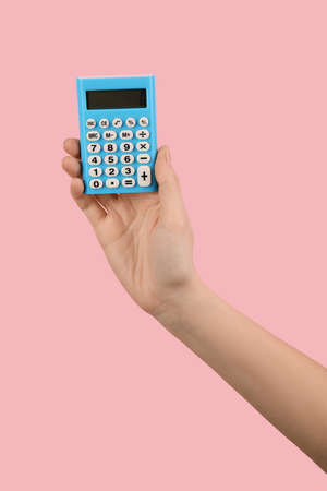 Woman with calculator on color backgroundの写真素材