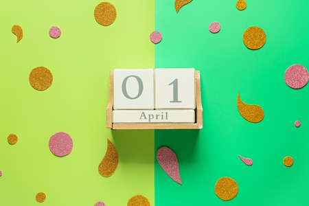 Calendar with date of April Fools Day on color background