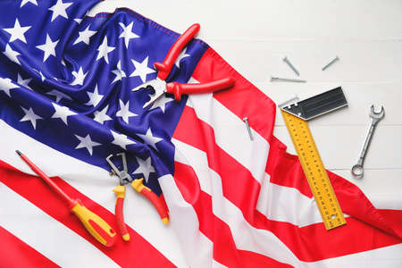 Set of tools and USA flag on white background. Labor Day celebration