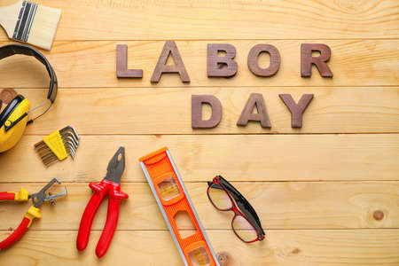 Set of tools and text LABOR DAY on wooden backgroundの写真素材