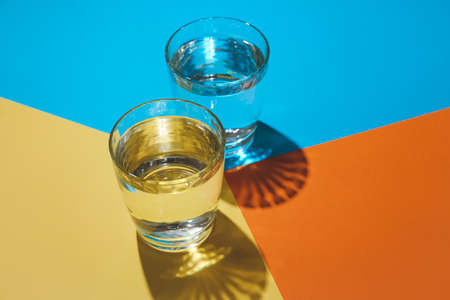 Glasses of water on colorful backgroundの写真素材