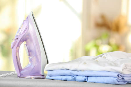 Electric iron with clean clothes at homeの写真素材