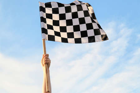 Woman with racing flag outdoorsの写真素材