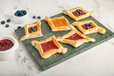 Board with danish pastry on light backgroundの写真素材