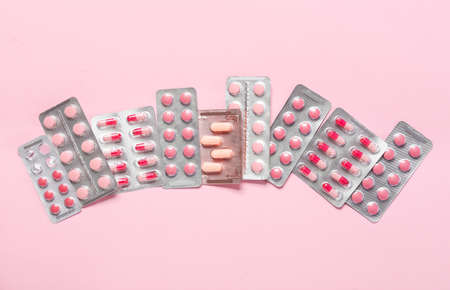Different pills on color background