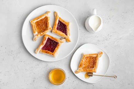 Plates with Danish pastry on light backgroundの写真素材