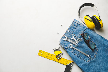Set of tools with jeans and eyeglasses on white background