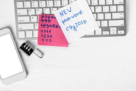 Composition with mobile phone and keyboard on white wooden background. Hacking conceptの写真素材