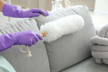 Young man cleaning his flatの写真素材