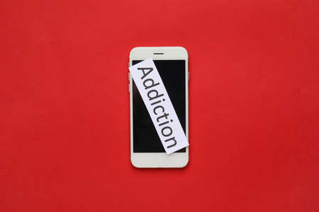 Mobile phone and word ADDICTION on color backgroundの写真素材
