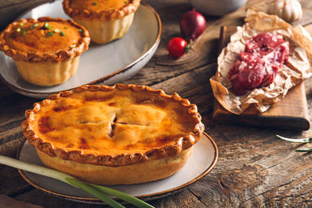 Tasty beef pot pies with meat on table