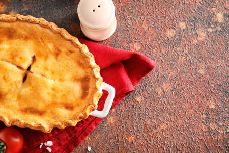 Tasty beef pot pie on color background